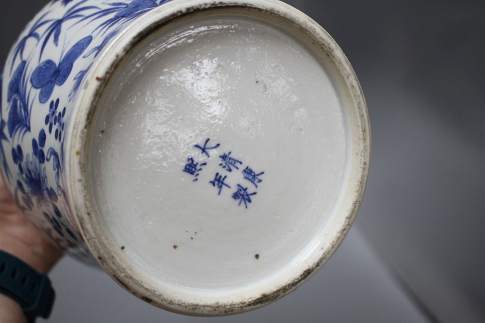 A pair of 19th century Chinese blue and white vases and covers, decorated with birds and flowers, height 23cm